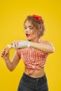 Side view of woman pressing whipped cream in waffle cone