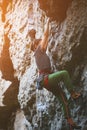 Young woman rock climber climbing on the cliff Royalty Free Stock Photo