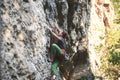 Young woman rock climber climbing on the cliff Royalty Free Stock Photo