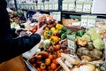 Woman shopping for fruits vegetables at supermarket in France