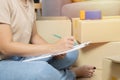 Side view of woman sit on floor and checking goods package or packing before delivery or prepare relocate and move to new house