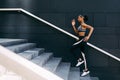 Side view of woman in sportswear running up the steps in the city Royalty Free Stock Photo