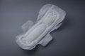 Side view of women sanitary pad on grey background