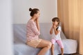 Side view of woman speech pathologist having lesson with little girl, language therapist practicing sounds pronunciation with kid