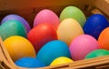 Side view of a wooden basket of multi-colored easter eggs