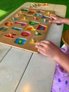 Side view of Wooden board of alphabet puzzle played by toddlers. Royalty Free Stock Photo