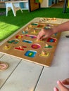 Side view of Wooden board of alphabet puzzle played by toddlers. Royalty Free Stock Photo