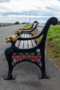 Side view of wooden and cast iron bench Lytham St Annes promenade Fylde June 2019