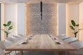 Side view on wooden conference table with modern laptops surrounded by white chairs in stylish meeting room with green plants near