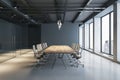 Side view on wooden conference table and stylish wheel chairs sunlit by modern chandelier on dark ceiling in spacious meeting room Royalty Free Stock Photo