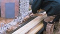 Side view of a worker putting the construction rope out of the concrete and metal block at the construction site. Clip Royalty Free Stock Photo