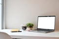 Side view workspace computer laptop, coffee, notebook with pen on white table