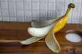 Side view of a yellow banana with peeled off skin Royalty Free Stock Photo