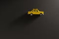 Yellow toy taxi car on a black background. Royalty Free Stock Photo