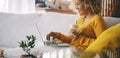 Side view of young adult woman have relax leisure at home using laptop and drinking. MOdern female people with computer sitting on Royalty Free Stock Photo