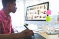 Graphic designer working on graphic tablet and computer at desk in office Royalty Free Stock Photo