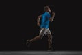 One young African-American man, athlete isolated over black background. Royalty Free Stock Photo