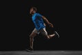 One young African-American man, athlete isolated over black background. Royalty Free Stock Photo