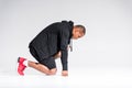 side view of young african american sportsman in hoodie kneeling Royalty Free Stock Photo