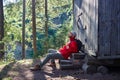 Inspired man sitting on stairs of wooden house Royalty Free Stock Photo