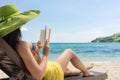 Young beautiful woman reading a book at the beach in a sunny day Royalty Free Stock Photo