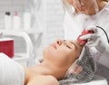 Attractive woman lying on procedure cleaning face.