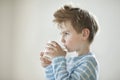 Side view of a young boy drinking milk Royalty Free Stock Photo