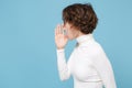 Side view of young brunette woman in casual white clothes eyeglasses posing isolated on pastel blue background. People Royalty Free Stock Photo