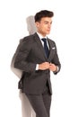 Side view of a young business man buttoning his suit Royalty Free Stock Photo