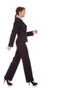 Side view of a young business woman walking Royalty Free Stock Photo