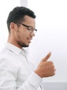 Side view. young businessman showing thumb up. Royalty Free Stock Photo