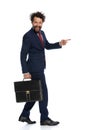 Young businessman walking and pointing to the side Royalty Free Stock Photo
