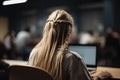 Side view of a young businesswoman sitting at her desk and working on laptop in the office, A high school girl with flowing open Royalty Free Stock Photo