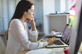 Female fashion designer working on laptop at desk in a modern office Royalty Free Stock Photo