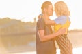 side view of young couple going to kiss on river beach Royalty Free Stock Photo