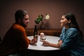 Side view of young couple in love enjoying talking, having fun together, celebrating Valentines day dining during Royalty Free Stock Photo