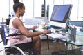 Disabled businesswoman working on computer at desk Royalty Free Stock Photo