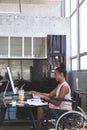 Disabled businesswoman working on computer at desk Royalty Free Stock Photo