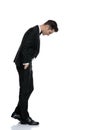 Side view of young elegant groom walking and looking down Royalty Free Stock Photo