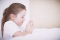 Thank you God for everything. Side view of a young girl kneeling by her bed and saying her prayers. Royalty Free Stock Photo