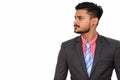 Side view of young handsome Indian businessman Royalty Free Stock Photo