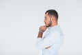 Side view. Young handsome man standing indoors against white background Royalty Free Stock Photo