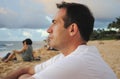 Side view of a young handsome man watching the sunset in Sunset Beach, Oahu, Hawaii Royalty Free Stock Photo