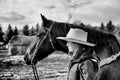 Side view of a young horse woman and her horse