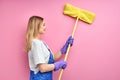 side view on young housewife cleaning wall