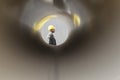 Side view of young male architect through large pipe at construction site