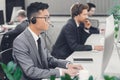 Side view of young male call center operators working together Royalty Free Stock Photo