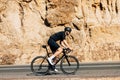 Side view of a young male cyclist riding his bicycle Royalty Free Stock Photo