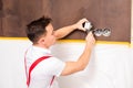 The electrician is fixing electrical wires for wall socket Royalty Free Stock Photo