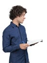 Side view of young man in blue denim shirt with curly hairs, hol Royalty Free Stock Photo